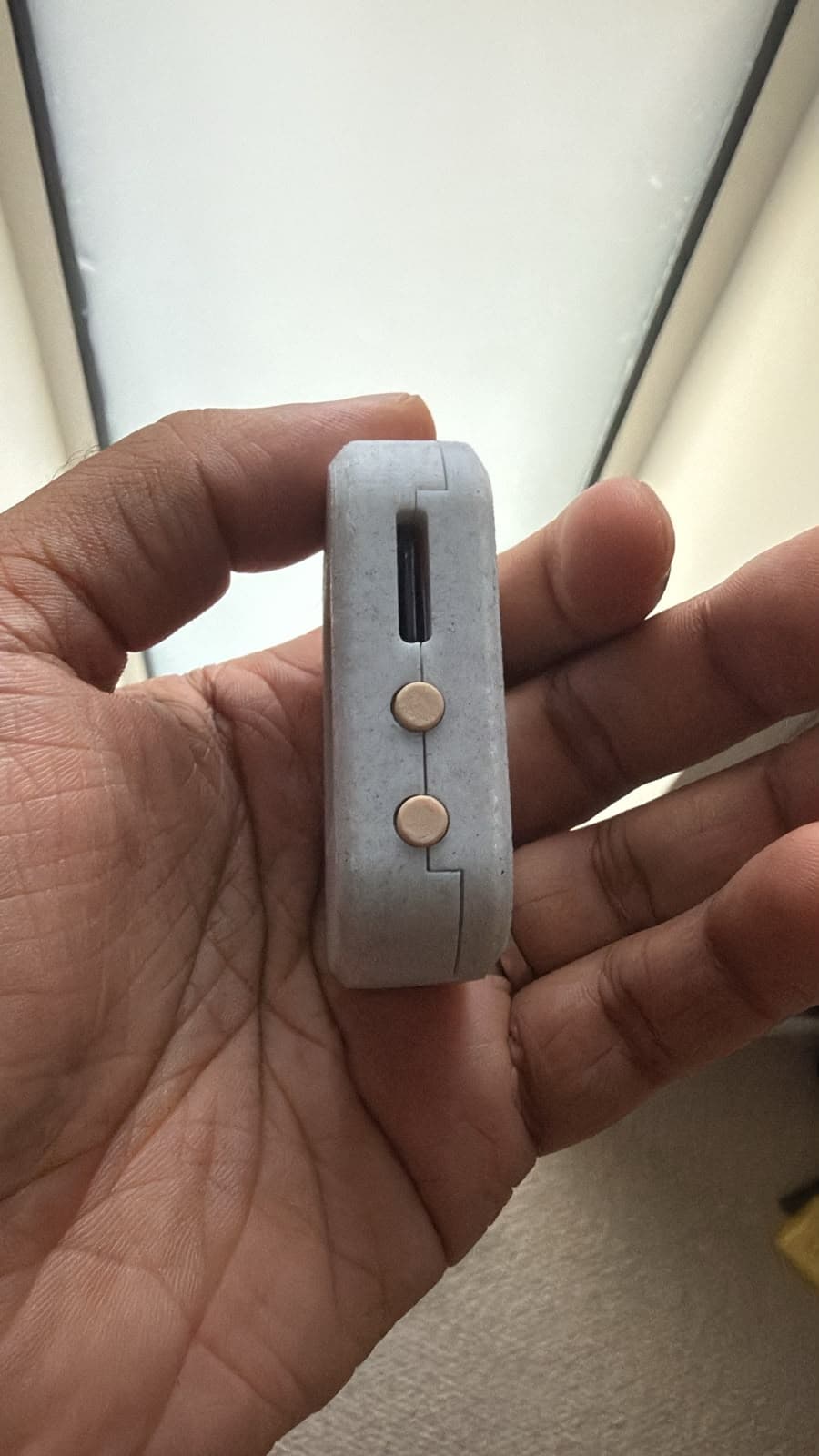 Side of the early Aira hardware prototype showing two round physical buttons
